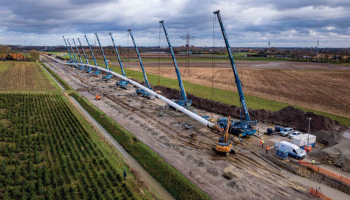 A HDD Arc, showing pipe held by 7 cranes